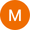 A solid orange circle with a white, uppercase letter "M" in the center.